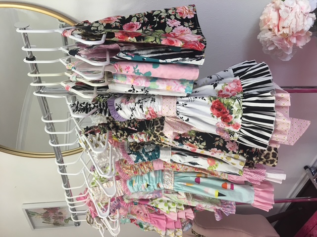 Rack of handmade boutique twirl dresses sewn from 100% quilting cotton fabric by the yard Rack of handmade boutique twirl dresses sewn from 100% quilting cotton fabric by the yard