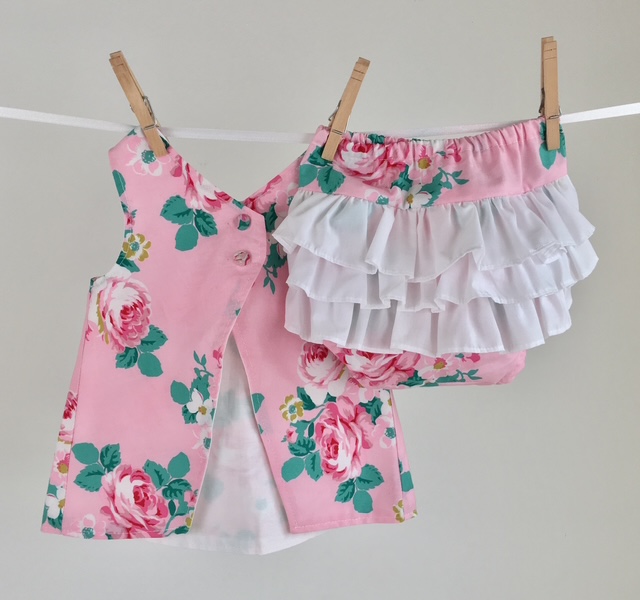Pink floral quilting cotton pinafore dress and white ruffle bloomers made from 100% woven cotton fabric Pink floral quilting cotton pinafore dress and white ruffle bloomers made from 100% woven cotton fabric